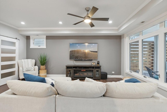 living room featuring ceiling fan, a healthy amount of sunlight, and hardwood / wood-style flooring