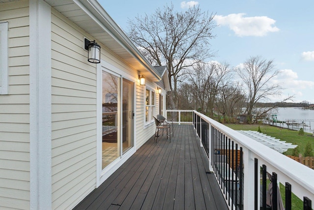 wooden deck featuring a water view