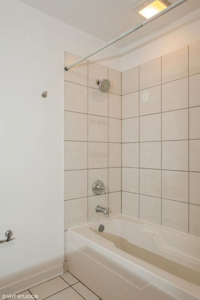 bathroom with tiled shower / bath combo and tile patterned floors