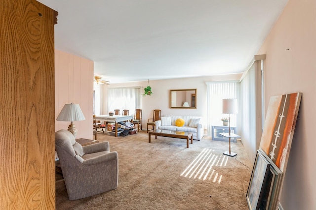 carpeted living room featuring ceiling fan