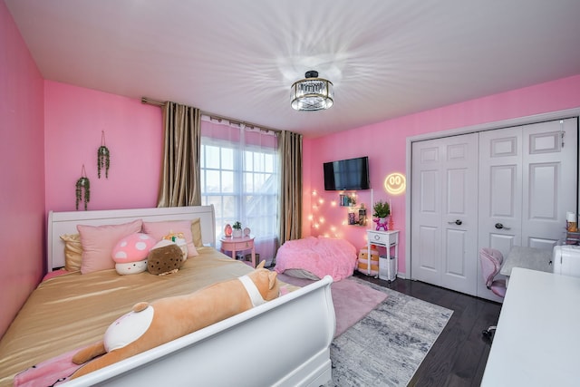 bedroom with a closet and dark hardwood / wood-style floors