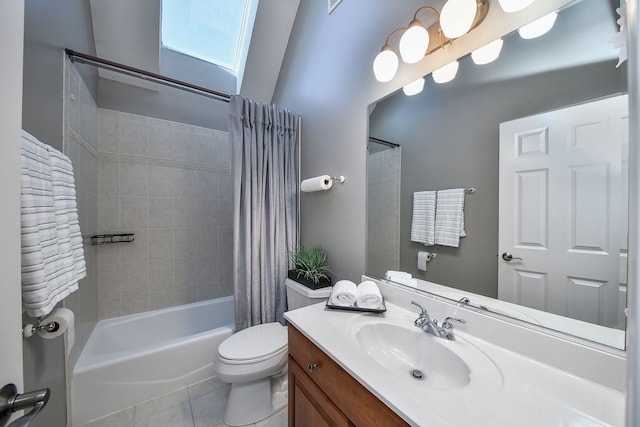 full bathroom with a skylight, tile patterned flooring, toilet, vanity, and shower / tub combo