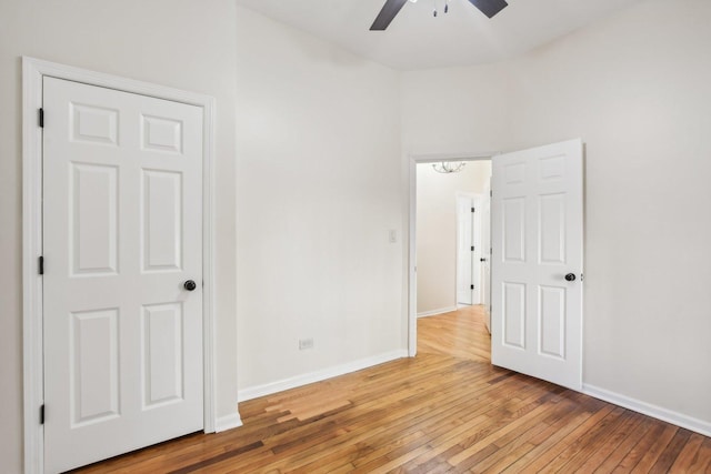 unfurnished bedroom featuring ceiling fan and hardwood / wood-style flooring