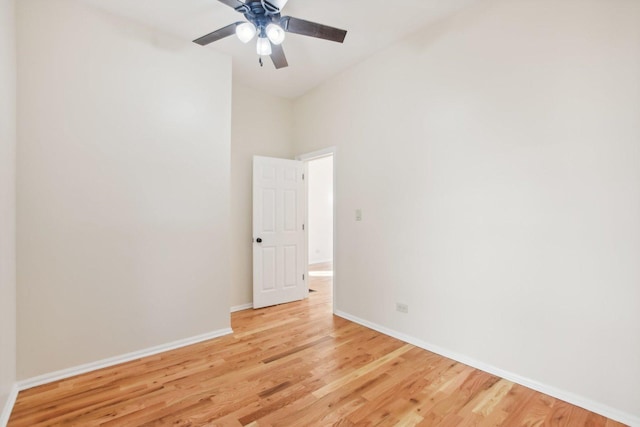 unfurnished room with a towering ceiling, light hardwood / wood-style floors, and ceiling fan