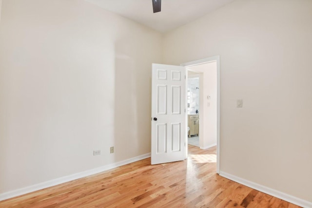 spare room with ceiling fan and wood-type flooring