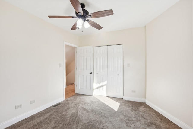 unfurnished bedroom featuring ceiling fan, a closet, and carpet