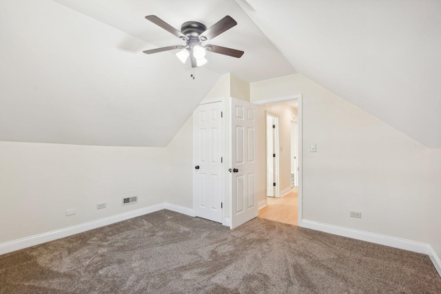 additional living space featuring ceiling fan, lofted ceiling, and light carpet