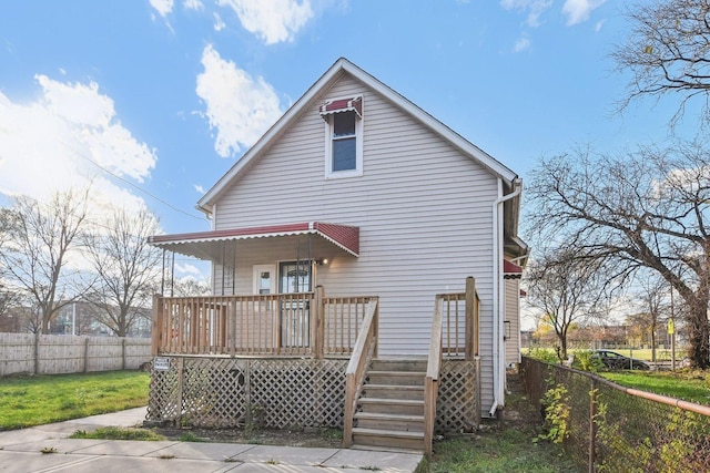 rear view of property with covered porch