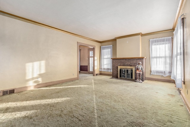 unfurnished living room with ornamental molding, a brick fireplace, and carpet floors