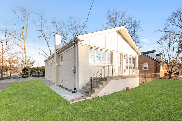 rear view of property with a lawn