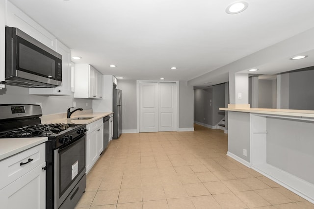 kitchen with sink, white cabinetry, and stainless steel appliances