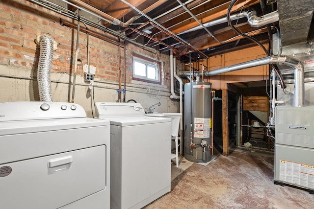 laundry room featuring water heater, washer and dryer, and heating unit