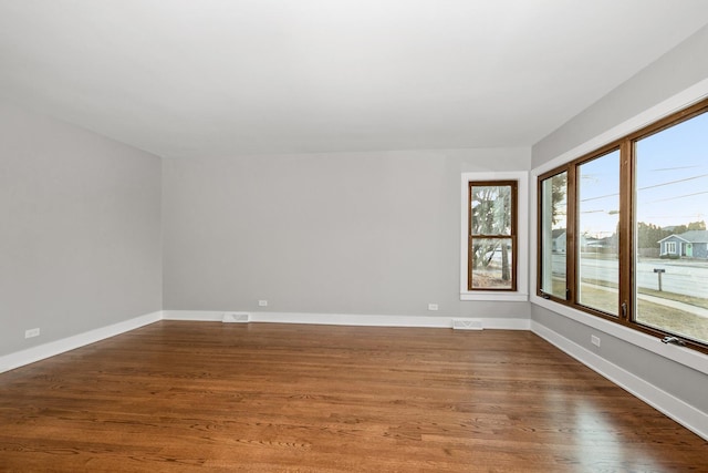 empty room featuring dark hardwood / wood-style flooring