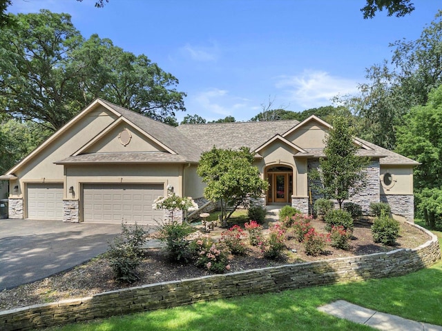 craftsman-style house with a garage, stone siding, roof with shingles, stucco siding, and driveway