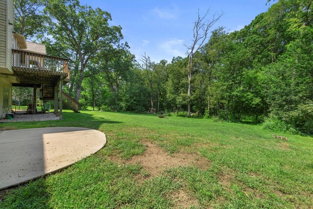 view of yard with stairs, a patio area, and a wooden deck