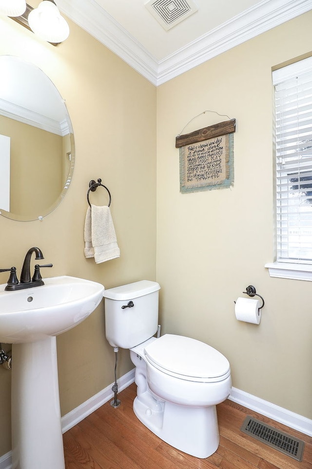 bathroom featuring sink, toilet, ornamental molding, and hardwood / wood-style flooring