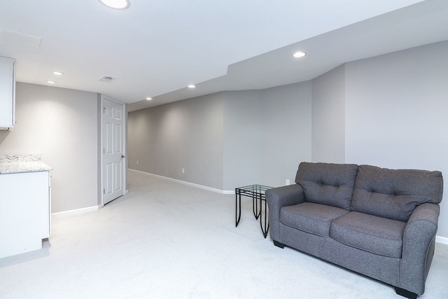 living area with light colored carpet