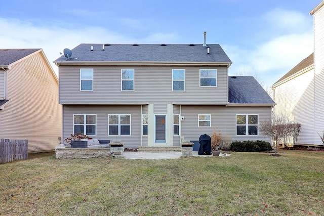 back of house with a lawn and a patio