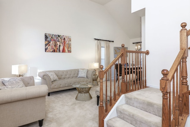 carpeted living room with a notable chandelier and lofted ceiling