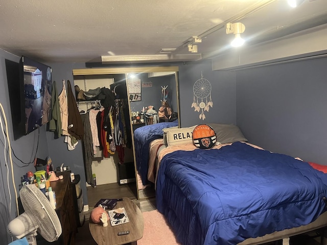 carpeted bedroom with rail lighting