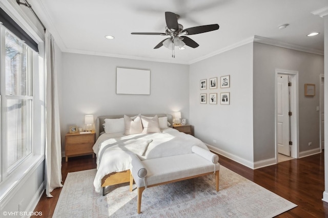 bedroom with dark hardwood / wood-style floors, ceiling fan, and crown molding