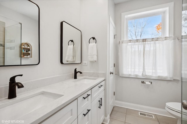 bathroom featuring tile patterned flooring, vanity, and toilet