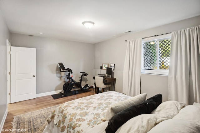 bedroom with hardwood / wood-style flooring