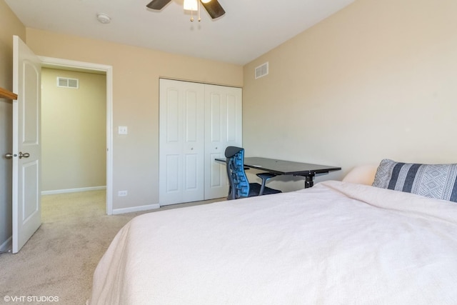 carpeted bedroom featuring a closet and ceiling fan