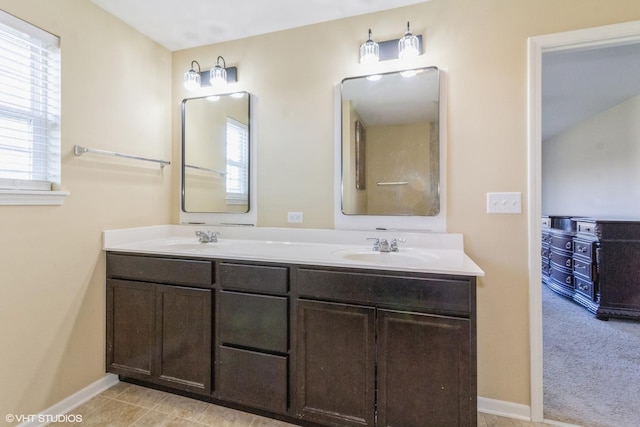 bathroom featuring tile patterned flooring, vanity, and a healthy amount of sunlight