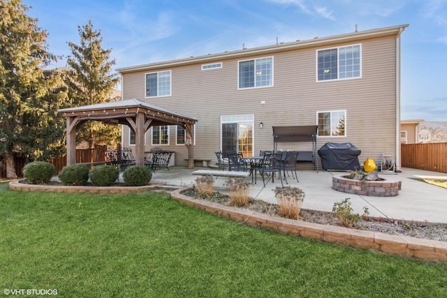 rear view of property featuring a lawn and a patio area