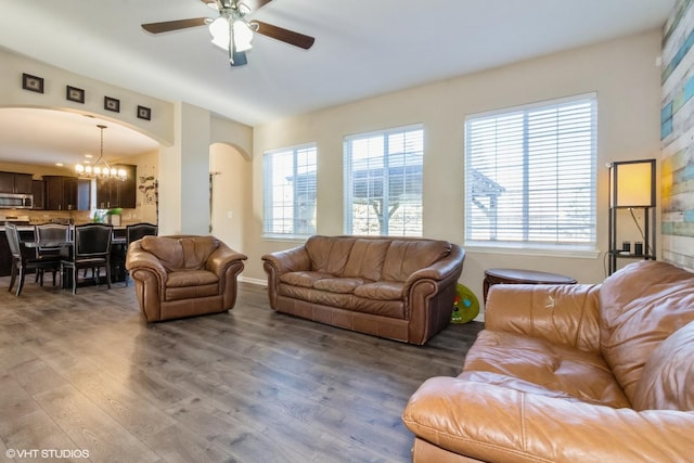 living room with hardwood / wood-style floors and ceiling fan with notable chandelier