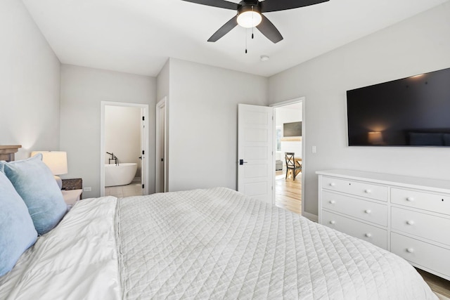 bedroom featuring ceiling fan, ensuite bathroom, and light wood-type flooring