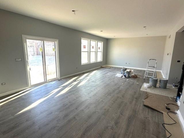 unfurnished living room with dark wood-type flooring