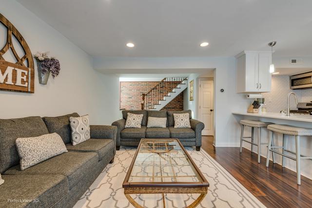 living room featuring dark hardwood / wood-style floors and sink