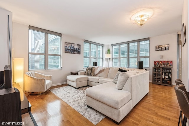 living room with light hardwood / wood-style floors and floor to ceiling windows