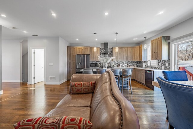 living room featuring dark wood-type flooring and sink