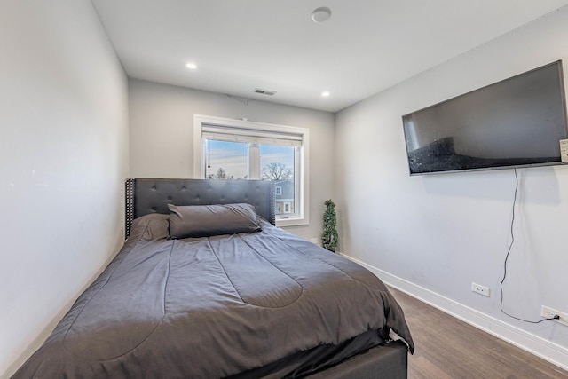 bedroom with wood-type flooring