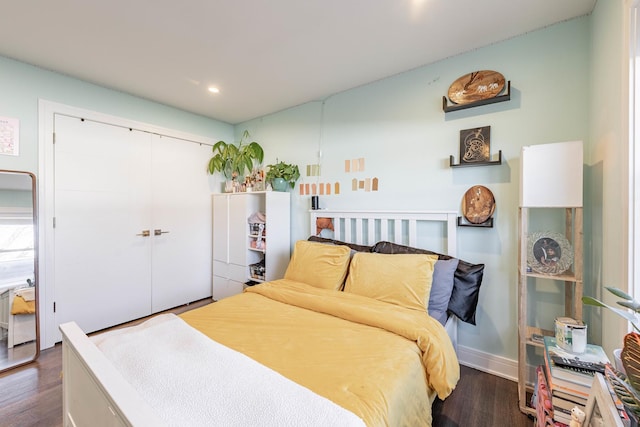 bedroom featuring a closet and dark hardwood / wood-style floors