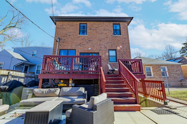 back of property with an outdoor living space, a deck, and a patio