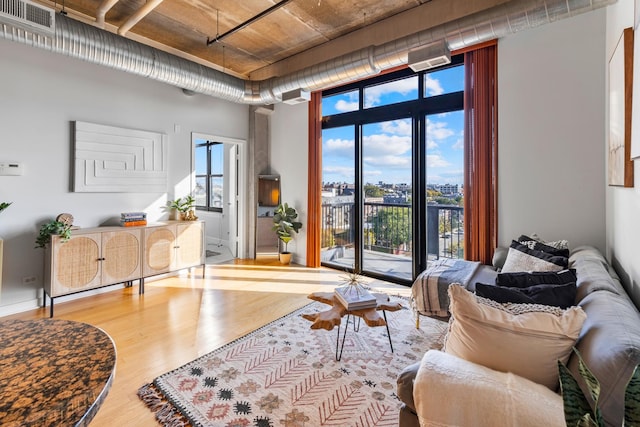 living room with floor to ceiling windows and wood-type flooring