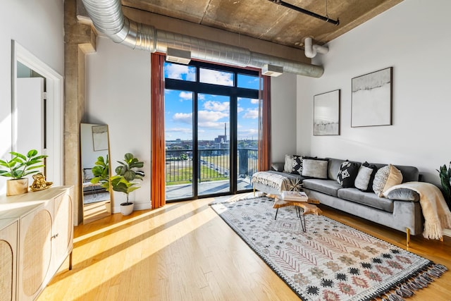 living room with a wall of windows and hardwood / wood-style flooring