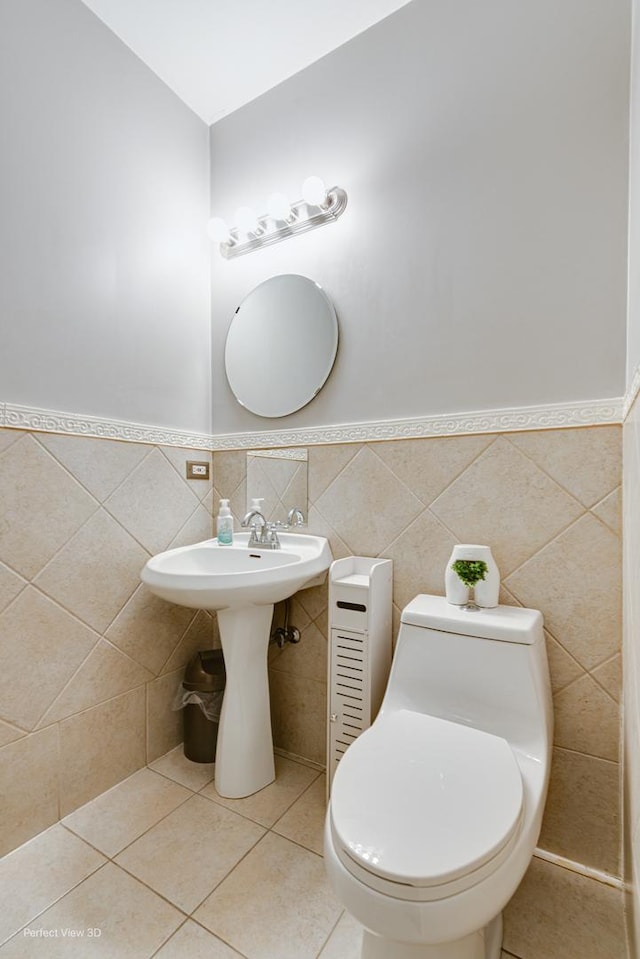 bathroom with tile walls, toilet, and tile patterned floors