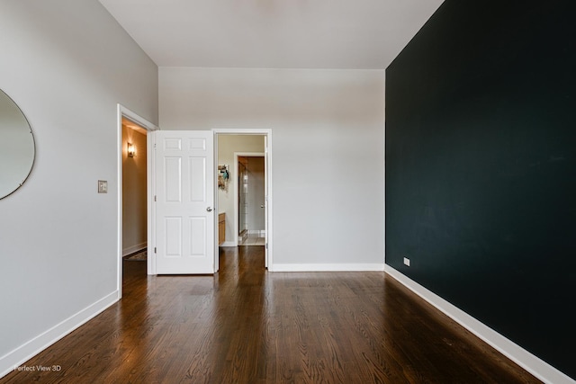 spare room with dark hardwood / wood-style flooring