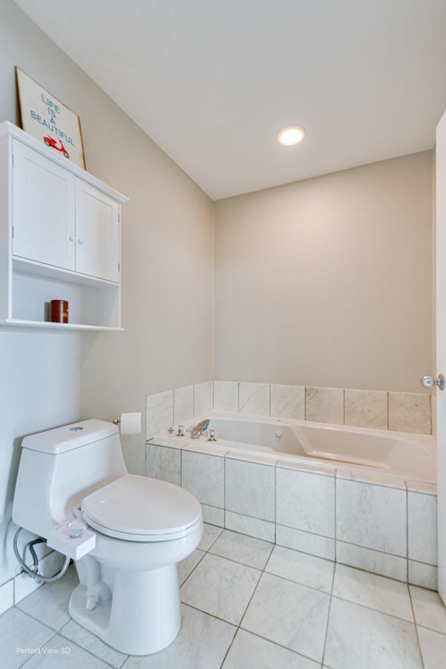 bathroom with toilet, tile patterned flooring, and a relaxing tiled tub