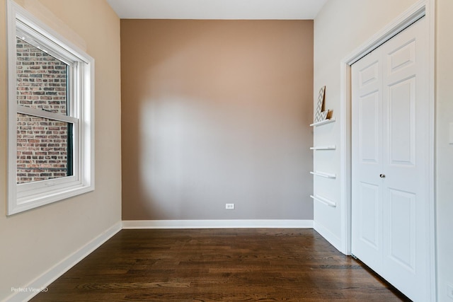 spare room featuring dark wood-type flooring