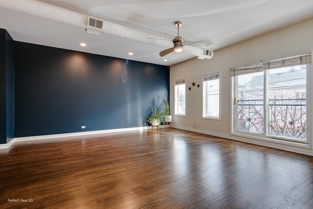 unfurnished room featuring ceiling fan and dark wood-type flooring