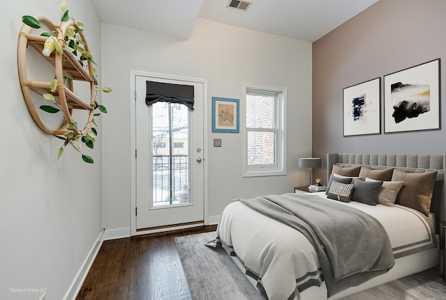 bedroom featuring dark hardwood / wood-style flooring and access to exterior