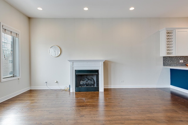 unfurnished living room featuring dark hardwood / wood-style floors