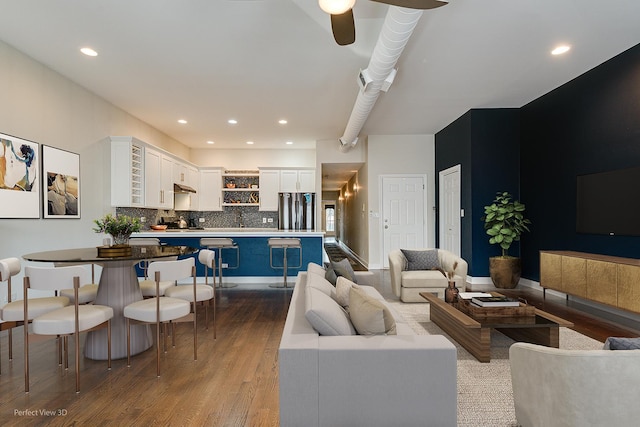 living room featuring light wood-type flooring and ceiling fan