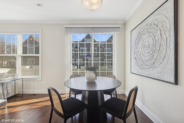 dining area featuring crown molding and dark wood-type flooring